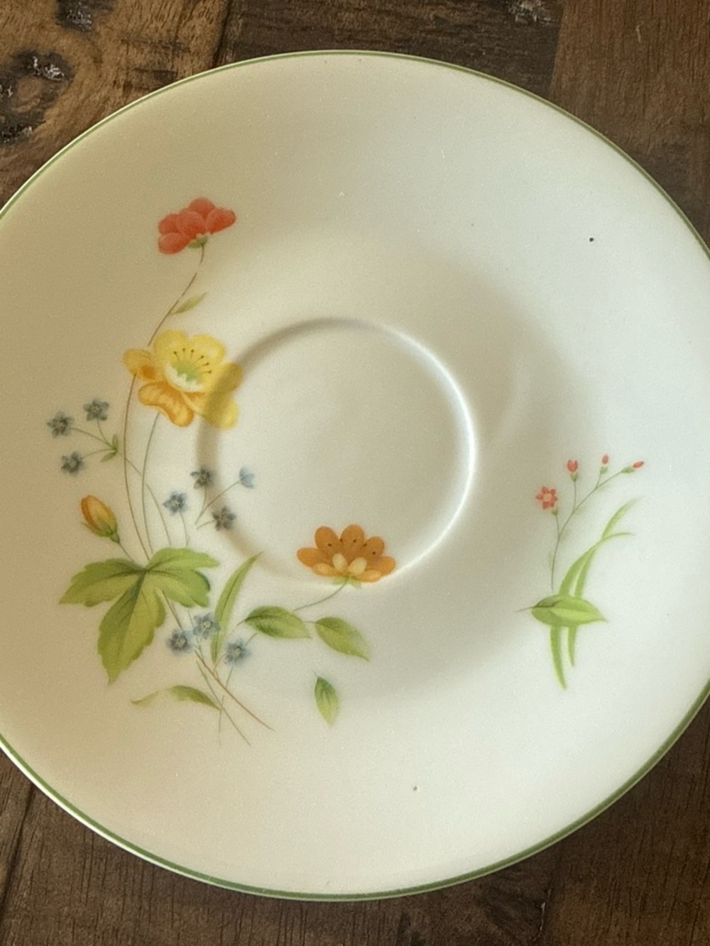 White Porcelain Saucer with Green Rim and Floral Accent